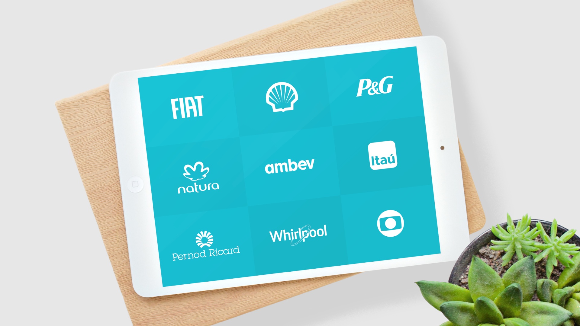 An ipad showing the logos of various companies such as Fiat, Shell, P&G, Natura, Ambev, Itau, Pernod Ricard, Whirlpool and Globo.